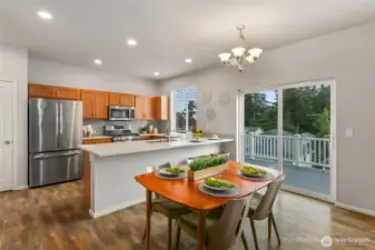 Spacious and open dining area with slider to huge rear deck is perfect for hosting friends and family