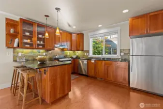 Spacious kitchen with cherry cabinets and granite counters