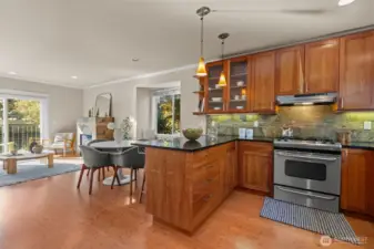 Open kitchen and living area features bamboo floors and high ceiings
