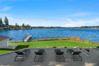 An expansive, three-level 2,600 sq. ft. patio showcases sweeping west-facing views of Lake Goodwin—perfect for soaking in the sun and breathtaking sunsets.