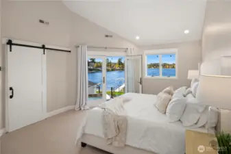 Main-level Primary opens to the hot tub offering crystal blue waters.