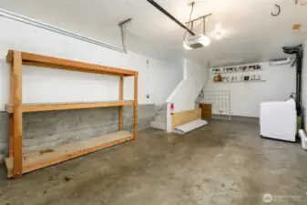 Large attached garage with extra storage space and laundery area.