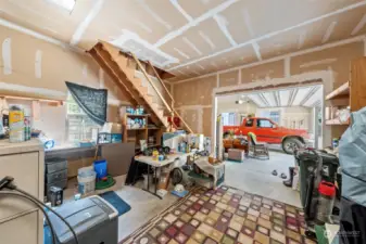 Spacious shop/storage area with loft and garage are just off the kitchen area.
