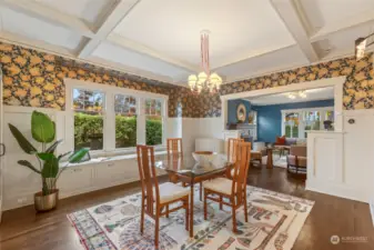 Large formal dining area with walls of windows and bench seating.