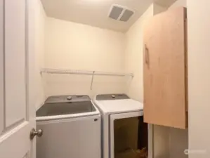 Laundry room with ironing board