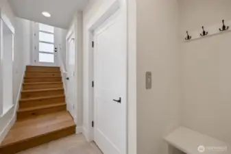 Gorgeous hardwood flooring on stairs. Door to elevator on the right.