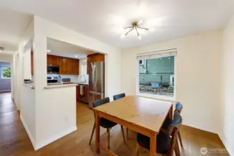 Dining area toward kitchen and hall to bedrooms on left.