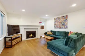 Living room with wood burning fireplace.