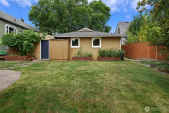 Note raised garden beds. So much room and light in backyard to grow to one's delight.