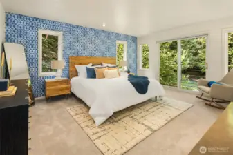 Spacious primary bedroom with new carpet, multiple windows & sliding glass door out to Juliet balcony overlooking the backyard.