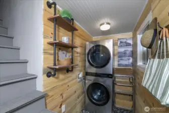 Laundry room, with stairs to upper floor.