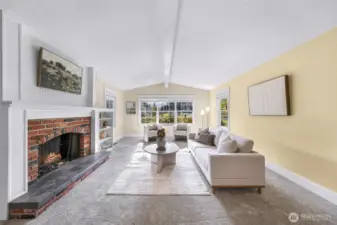 Charming wood burning fireplace anchors the room