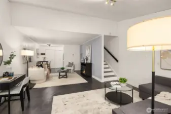 Modern-Rich toned cement flooring. Home features fresh paint, updated light sconces, and LVP stairwell flooring.