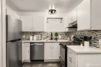 New stainless refrigerator and dishwasher, quartz counter tops, designer back splash tiles. Contemporary under-mount sink, and updated lighting makes this Kitchen the one you want to spend time in.