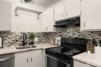 New stainless refrigerator and dishwasher, quartz counter tops, designer back splash tiles. Contemporary under-mount sink, and updated lighting makes this Kitchen the one you want to spend time in.