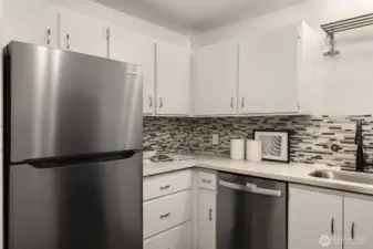New stainless refrigerator and dishwasher, quartz counter tops, designer back splash tiles. Contemporary under-mount sink, and updated lighting makes this Kitchen the one you want to spend time in.