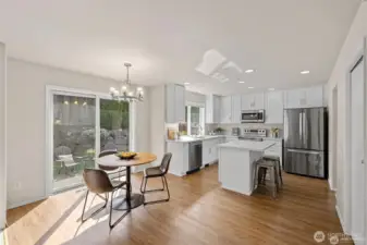 Experience the ultimate in modern living with an open-concept family room and kitchen designed for connection. Bathed in bright, natural light, this expansive space feels both grand and incredibly welcoming.  ?The brand-new kitchen—boasting modern finishes and a functional layout—flows effortlessly into the cozy family room, making it the perfect hub for daily life or weekend entertaining. At the center of it all, a warm gas fireplace serves as a stunning focal point, offering the perfect glow for chilly PNW evenings. Whether you're prepping a meal or relaxing on the sofa, this sun-drenched sanctuary is where your best memories will be made.