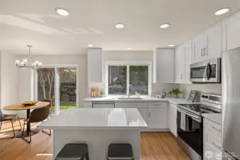 Experience the ultimate in modern living with an open-concept family room and kitchen designed for connection. Bathed in bright, natural light, this expansive space feels both grand and incredibly welcoming.  ?The brand-new kitchen—boasting modern finishes and a functional layout—flows effortlessly into the cozy family room, making it the perfect hub for daily life or weekend entertaining. At the center of it all, a warm gas fireplace serves as a stunning focal point, offering the perfect glow for chilly PNW evenings. Whether you're prepping a meal or relaxing on the sofa, this sun-drenched sanctuary is where your best memories will be made.