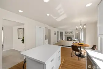 Experience the ultimate in modern living with an open-concept family room and kitchen designed for connection. Bathed in bright, natural light, this expansive space feels both grand and incredibly welcoming.  ?The brand-new kitchen—boasting modern finishes and a functional layout—flows effortlessly into the cozy family room, making it the perfect hub for daily life or weekend entertaining. At the center of it all, a warm gas fireplace serves as a stunning focal point, offering the perfect glow for chilly PNW evenings. Whether you're prepping a meal or relaxing on the sofa, this sun-drenched sanctuary is where your best memories will be made.