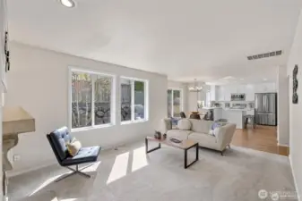 Experience the ultimate in modern living with an open-concept family room and kitchen designed for connection. Bathed in bright, natural light, this expansive space feels both grand and incredibly welcoming.  ?The brand-new kitchen—boasting modern finishes and a functional layout—flows effortlessly into the cozy family room, making it the perfect hub for daily life or weekend entertaining. At the center of it all, a warm gas fireplace serves as a stunning focal point, offering the perfect glow for chilly PNW evenings. Whether you're prepping a meal or relaxing on the sofa, this sun-drenched sanctuary is where your best memories will be made.