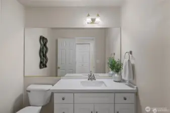 Sophisticated Main-Floor Essentials  ?Conveniently located for guests and daily life alike, the main-floor powder room makes a statement with its sleek, modern style.  ?Every detail has been curated to reflect a contemporary aesthetic, offering a polished and high-end feel that complements the home’s overall design. It’s a small space that delivers a big impact, ensuring that even the most functional rooms in the house feel stylish and intentionally crafted.