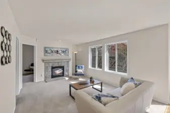 Experience the ultimate in modern living with an open-concept family room and kitchen designed for connection. Bathed in bright, natural light, this expansive space feels both grand and incredibly welcoming.  ?The brand-new kitchen—boasting modern finishes and a functional layout—flows effortlessly into the cozy family room, making it the perfect hub for daily life or weekend entertaining. At the center of it all, a warm gas fireplace serves as a stunning focal point, offering the perfect glow for chilly PNW evenings. Whether you're prepping a meal or relaxing on the sofa, this sun-drenched sanctuary is where your best memories will be made.