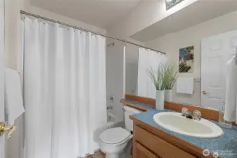 The three additional bedrooms on the upper floor are perfectly served by a bright, full-sized second bathroom. Designed with a busy household in mind, this well-appointed space ensures that everyone has room to get ready with ease. Its central location creates a dedicated wing for children or guests, balancing functional convenience with the home’s overall modern aesthetic.