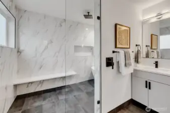 Primary bedroom’s bath with large walk-in shower and tub.