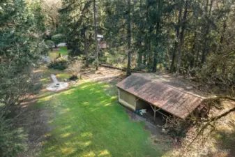Outbuilding looking back to fire pit are and home