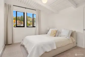 Serene primary bedroom with a huge walk-in closet that can actually fit all those shoes!
