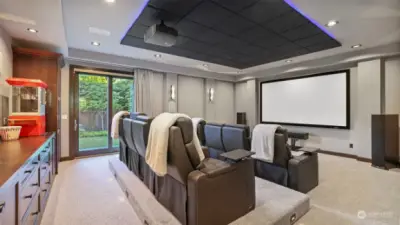 Media room offers spectacular viewing experience with 8 leather power-recliner seats, Sony projector, surround sound, block-out shade, wall of cabinets & wet bar!