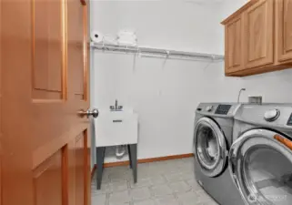 Laundry w/ storage, hanging shelf, and deep well sink