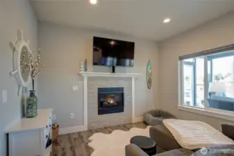Open concept living/dining/kitchen with access to the sunroom and sweeping water views.