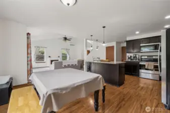 From dining to kitchen to living room, this shot gives you a peek at the effortless flow between spaces. The low-profile lighting in the dining room gives you flexibility for any setup, while the open layout ensures the home feels connected and airy.