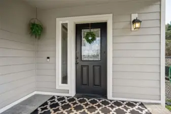 First impressions matter, and this front porch nails it. With a sleek black front door, tan paint, and crisp white trim, it’s the perfect mix of modern charm. The large covered space is ideal for seating, holiday displays, or potted plants, basically, it’s ready to welcome whatever you’ve got planned.