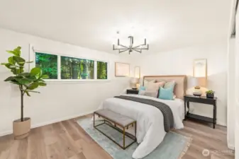 Primary bedroom with picturesque tree lined views of the backyard