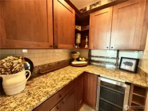 Butler's pantry w/ wine fridge and extra storage.