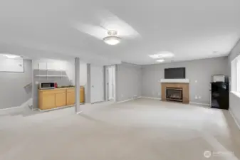 another view of the lower level with fireplace and separate entrance