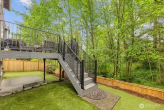 Stairs from main to ,lower level.  Turf installed for easy maintenance