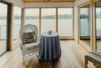 The doors open on both sides of this room as well as the living room to enjoy the summer breeze.