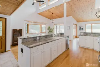 White cabinets, beautiful wood and stainless steel appliances make this home pop.