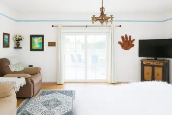 Just off the entry you'll find the bright living room. French doors lead to large deck on side of the house.