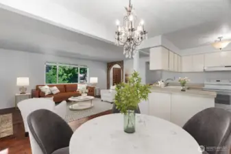 Virtually Staged Photo - Large windows in the living room and the glass slider off of the dining nook keep the home bright and offer nice views of the greenery outside.