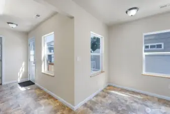 Dining area with vinyl floors and tons of natural light.