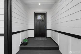 Covered front door and trex deck.