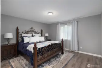 Primary bedroom looks to the backyard.