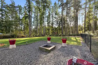 Firepit in fully fenced backyard.
