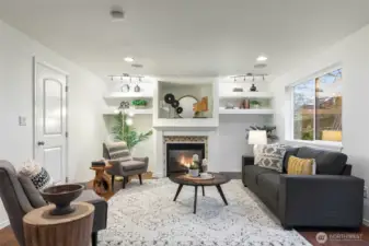 A second living room off the kitchen is anchored by a cozy, gas fireplace.