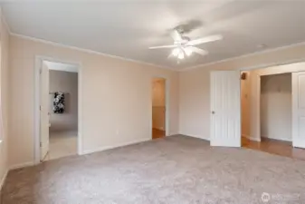 Primary bedroom with primary 5pc bath on left and large walk-in closet on right.