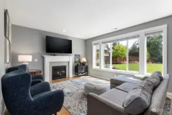 Large family room off of the kitchen looking into the beautifully landscaped backyard!